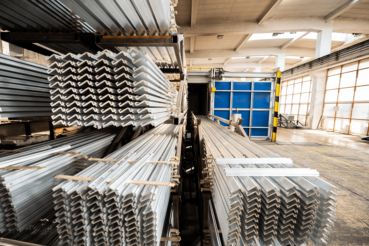 Stacks of metal beams in a warehouse.