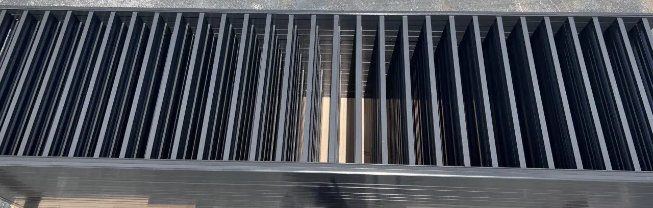 Metal bars arranged in parallel vertical lines.