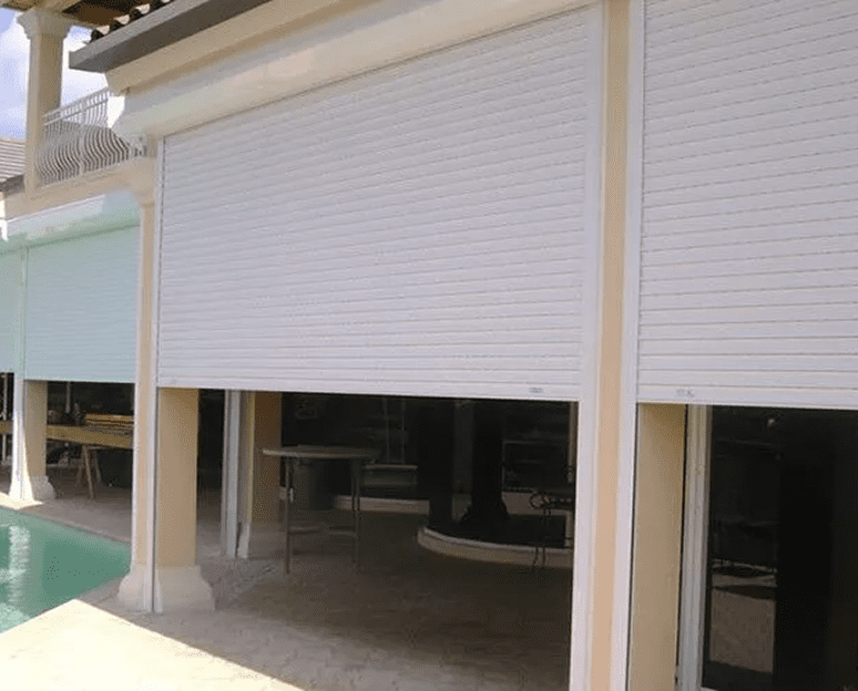 White outdoor shutters near a pool.
