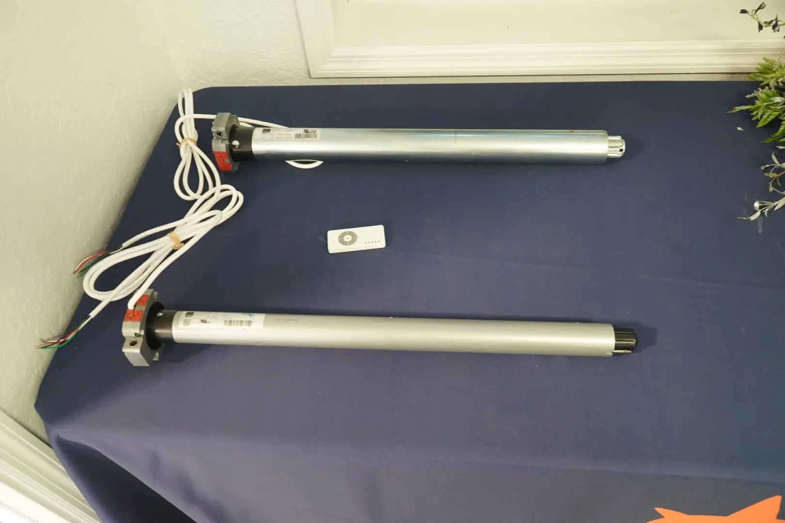 Two cylindrical devices with attached wires.