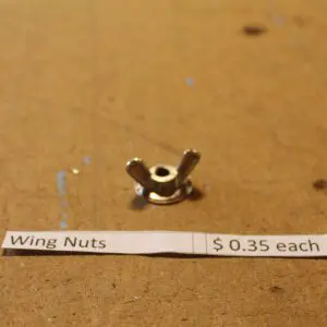 Wing nut with price tag on table.