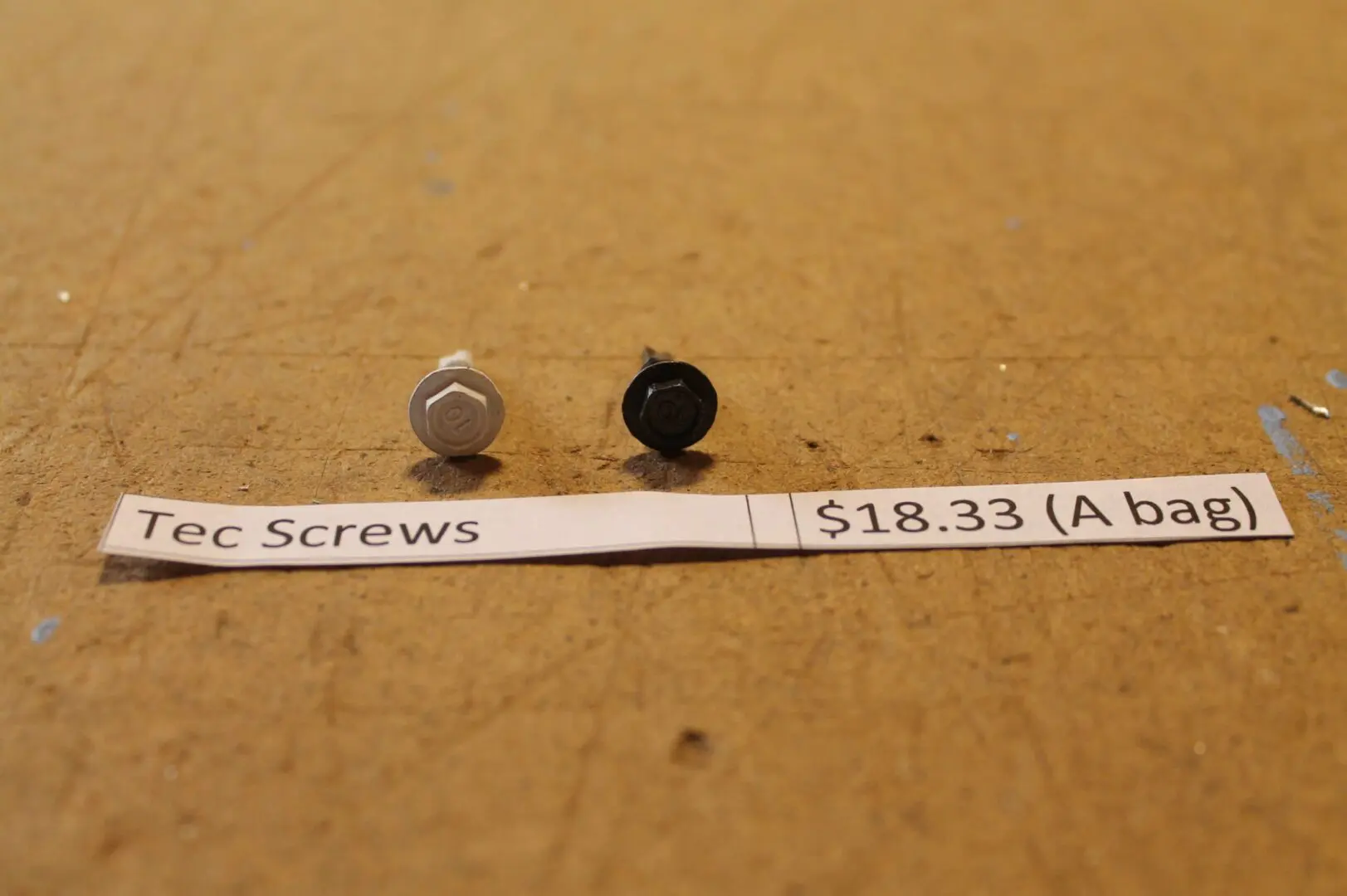 Two screws with price label displayed.