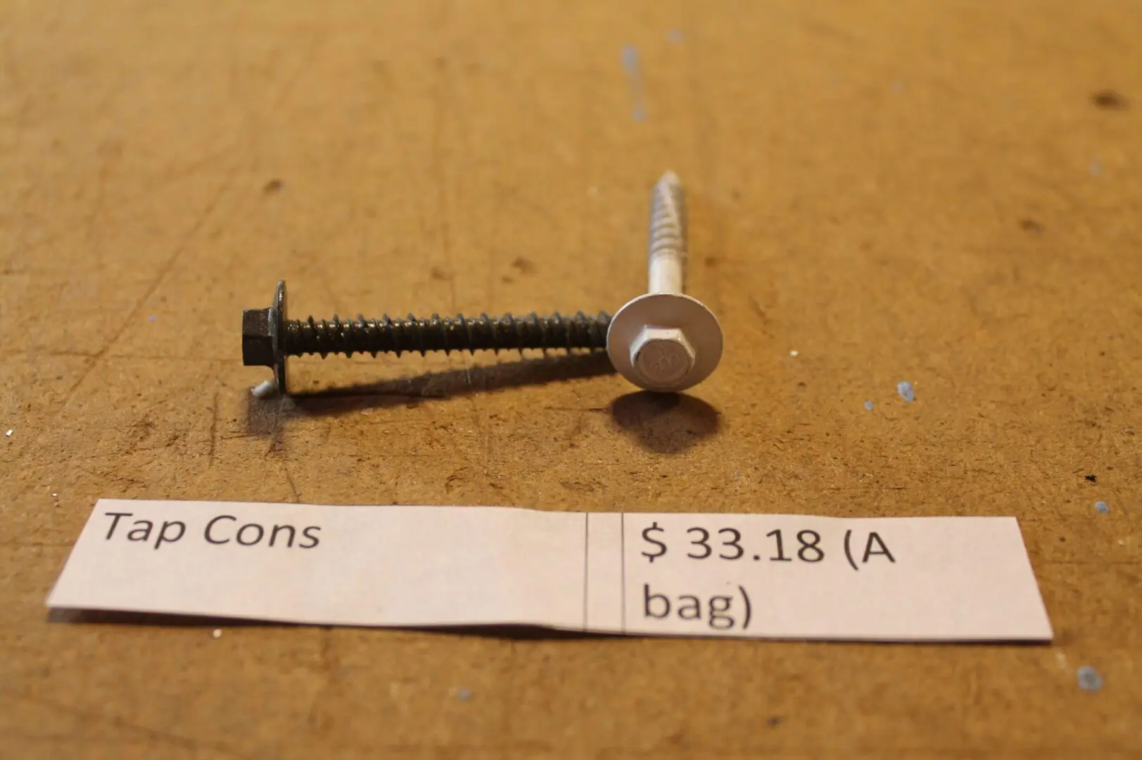 Tap cons with price label on table.