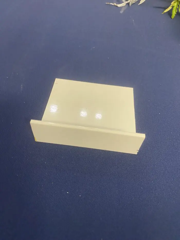 Small beige plastic card holder on table.