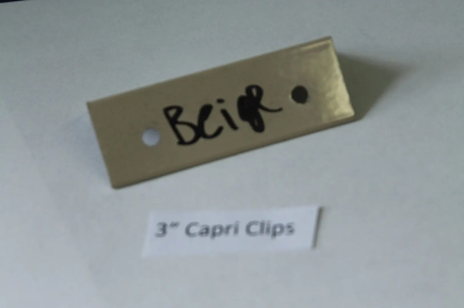 Beige sample with "3” Capri Clips" label.