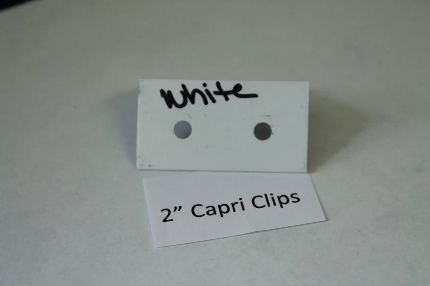 White 2" Capri Clips with two holes.