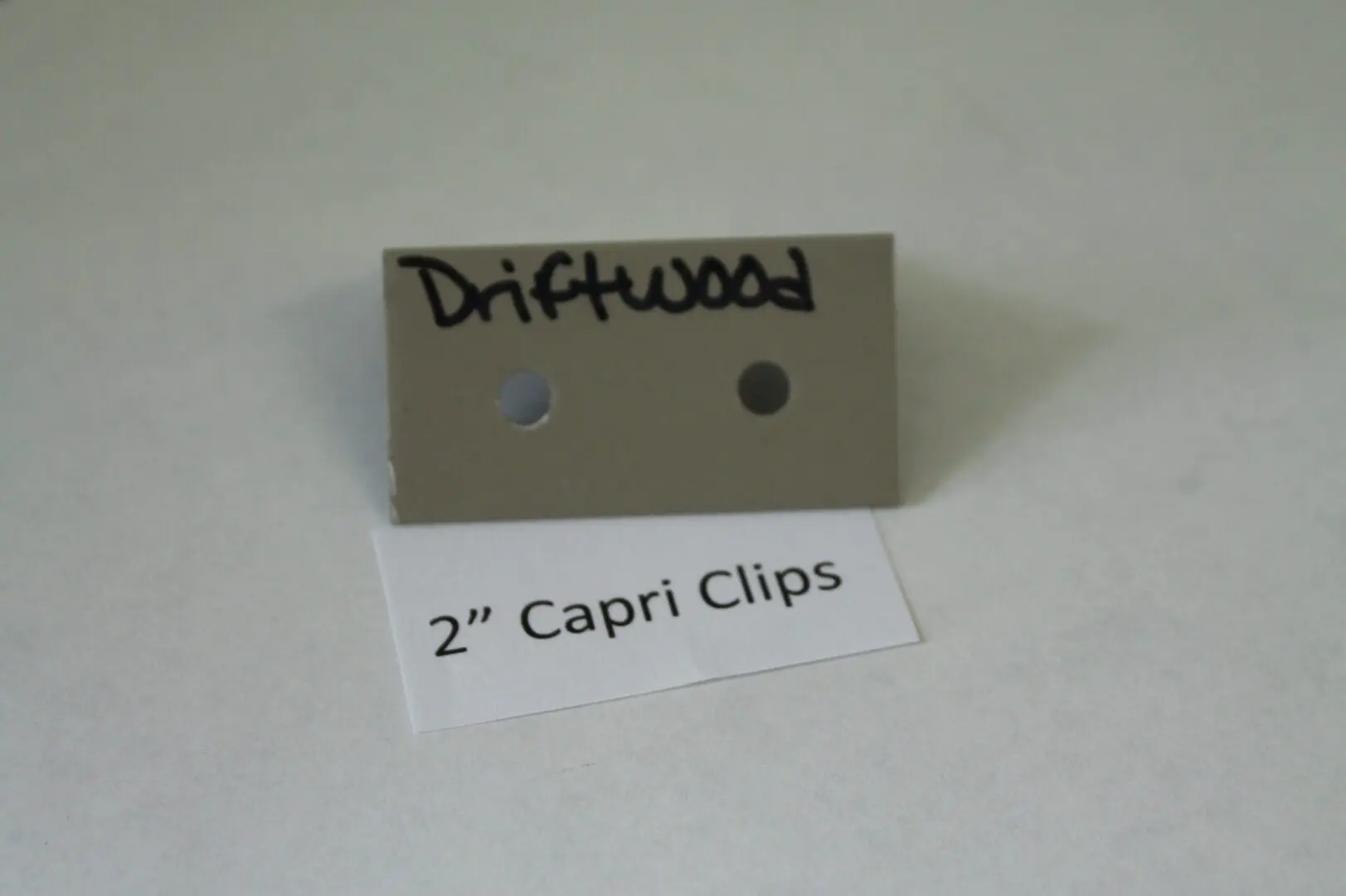 Driftwood color sample with Capri Clips label.