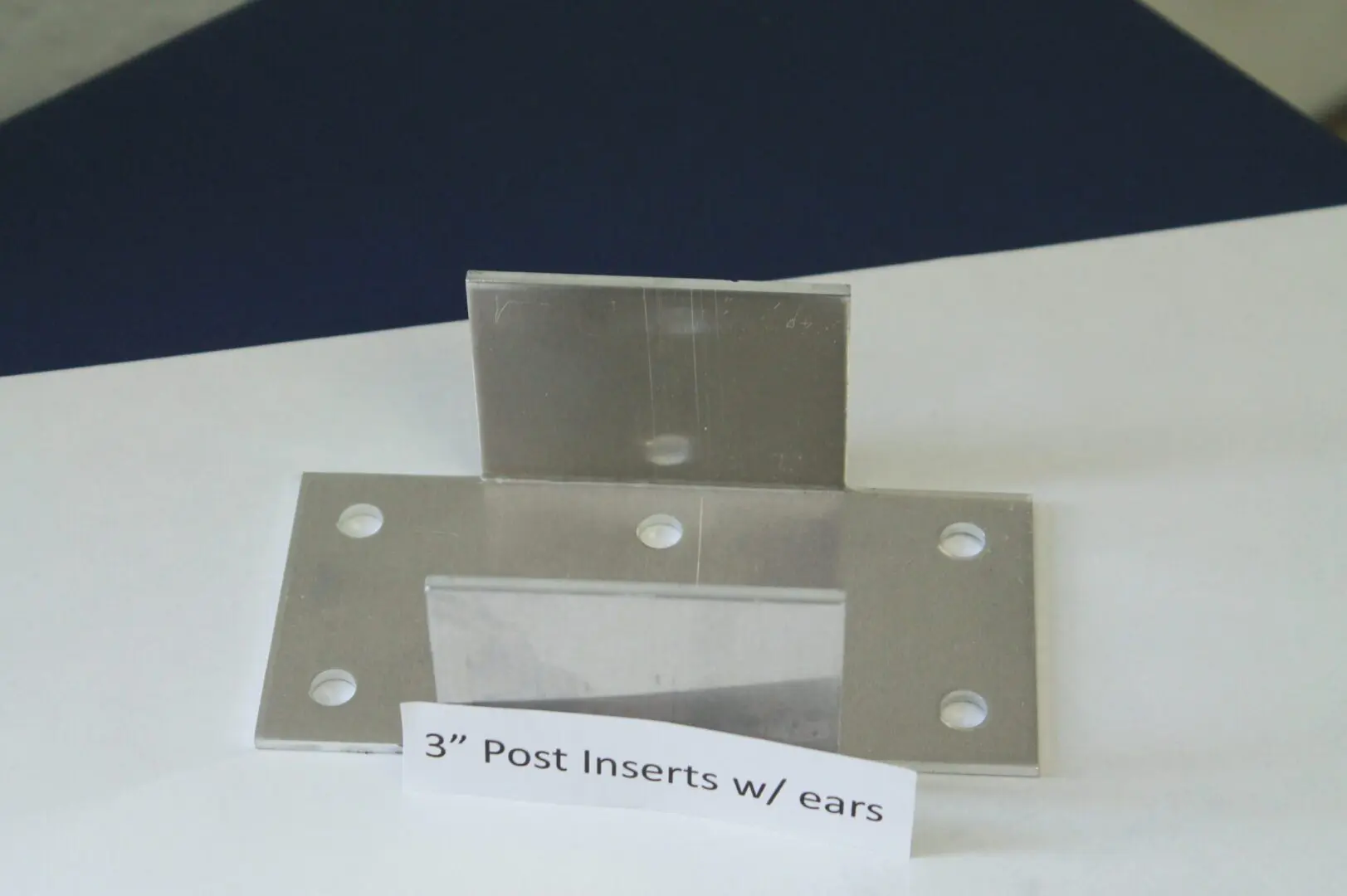 Metal post insert with labeled ears.