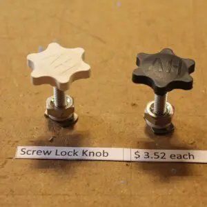 Two screw lock knobs on a table.