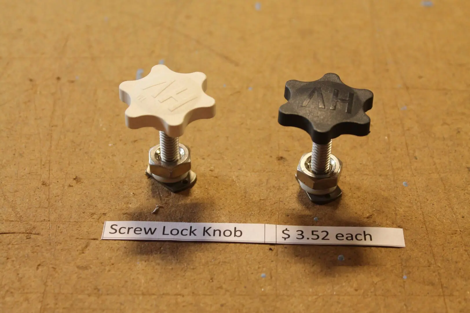 Two screw lock knobs on a table.