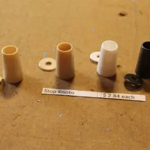Assorted stop knobs on a wooden surface.