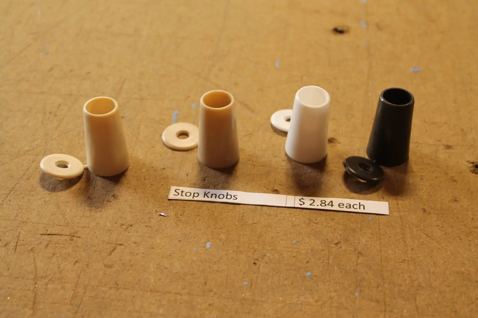 Assorted stop knobs on a wooden surface.