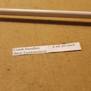 Crank handles price tag on wooden surface.