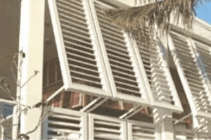 Building facade with white louvered panels.