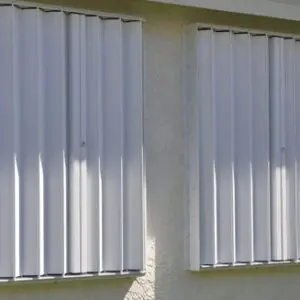 Metal hurricane shutters on two windows.