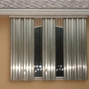 Metal storm shutters covering a window.