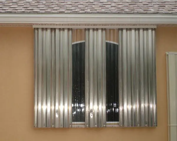 Metal storm shutters covering a window.