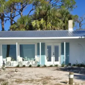 Single-story beach cottages with palm trees