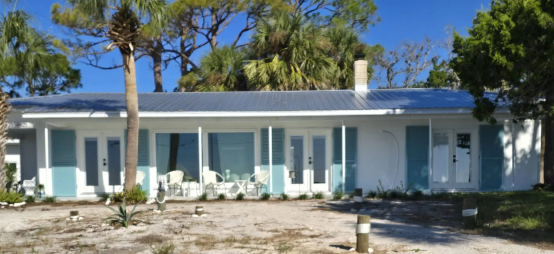 Single-story beach cottages with palm trees